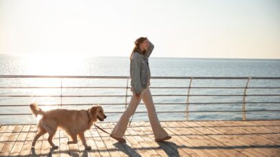 mulher-de-tiro-completo-com-cachorro-em-um-cais_23-2150558048 melhores horários para passear com pets